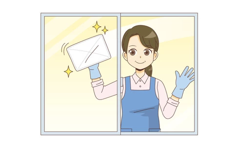 窓ふきをする女性ホームヘルパー