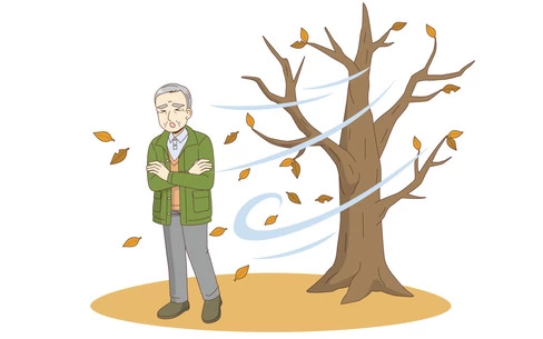 木枯らしに吹かれる男性高齢者