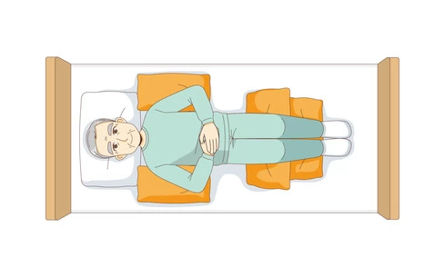 仰臥位（クッションあり・上から見た状態）（高齢者（おじいさん・おばあさん）/介護現場の人物）