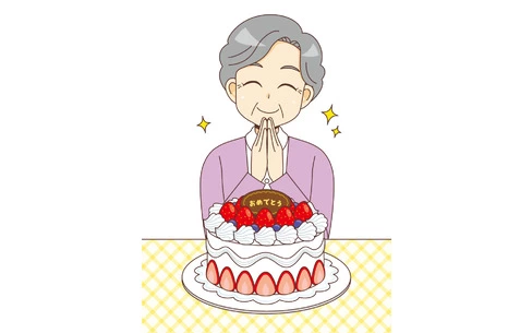 ケーキを前に微笑む女性高齢者（高齢者（おばあさん・おじいさん）/介護現場の人物）