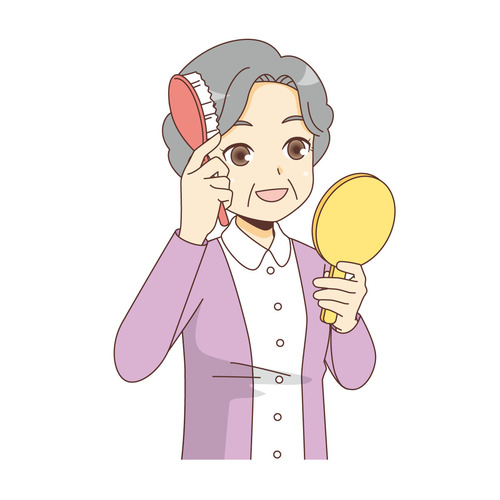 髪をとかす女性高齢者（高齢者（おばあさん・おじいさん）/介護現場の人物）